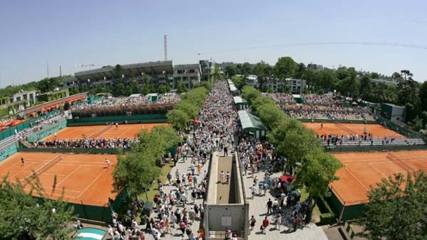 People walk in the alleys of Roland Garros during the Grand Slam tournament in Paris in 2005.