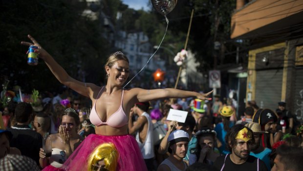 A reveler enjoys the "Ceu na Terra", or Heaven on earth, block party during Carnival celebrations in Rio de Janeiro, Brazil, Saturday, Feb. 6, 2016. Rio de Janeiro's over-the-top Carnival is the highlight of the year for many local residents. Hundreds of thousands of merrymakers are taking to the streets in hundreds of open-air "bloco" parties. (AP Photo/Leo Correa)