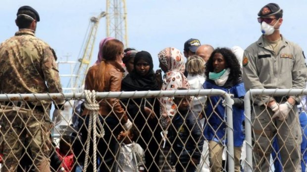 Earlier operation ... Migrants wait to disembark an Italian Navy ship in the port of Palermo, Sicily on May 2 after being evacuated from eight life rafts and one boat, which alone carried some 500 migrants. 