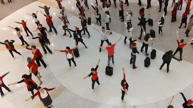 Go west ... a flash mob farewells passengers bound for Western Australia on the new 747 service.