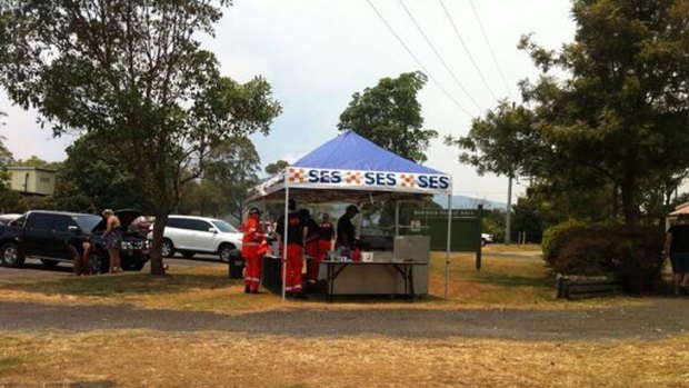 SES volunteers man a sausage sizzle for disappointed campers leaving North Stradbroke Island. Photo: Renae Henry/Ten News, via Twitter.