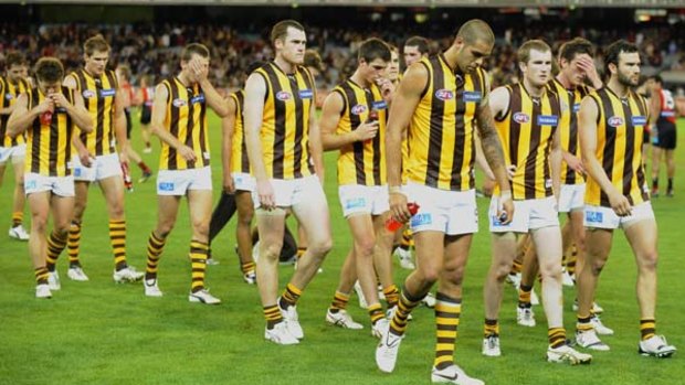 The Hawthorn team leaves the ground after losing to Essendon.