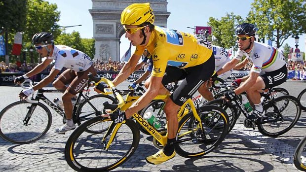 Bradley Wiggins of Britain takes a bend in front of the Arc de Triomphe during the final stage of the Tour de France.