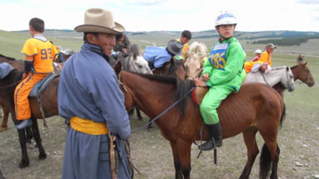 Lining up...Angus Paradice, with horse trainer Ulzil Byambajudger, gets ready to compete in the traditional horse races at the Nadaam festival in Mongolia.