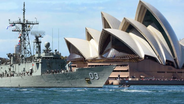 The HMAS Sydney passes the Sydney Opera House on October 4, 2013 as part of celebrations to commemorate 100 years since the Royal Australian Navy's fleet first entered the city's waters.