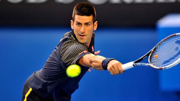 Black magic ... Novak Djokovic returns another David Ferrer shot on his way to a straight-sets victory.