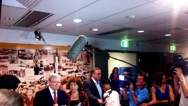 Telling the truth now? ... Kevin Rudd faces the media at Brisbane Airport today.