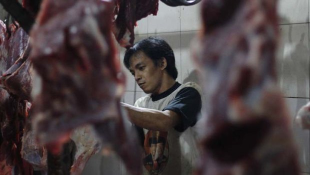 A worker at an Indonesian abattoir.