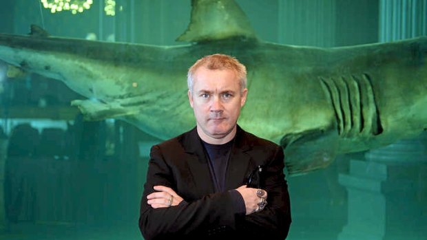 British artist Damien Hirst poses before his shark artwork.