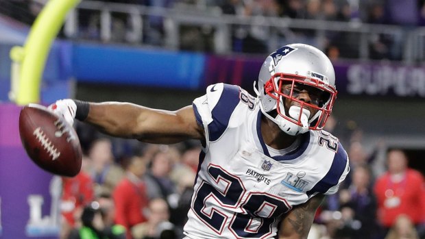 Patriots' James White celebrates his touchdown run during the first half.