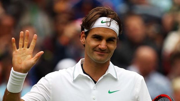 A relieved Roger Federer waves to the crowd after managing to defeat Xavier Malisse.