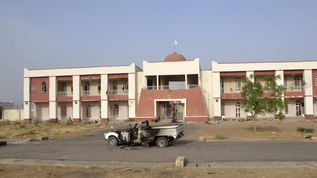 A burnt truck is seen in front of a building that Boko Haram insurgents used as their base before being driven out by the Chadian military in the northeast Nigerian town of Dikwa.