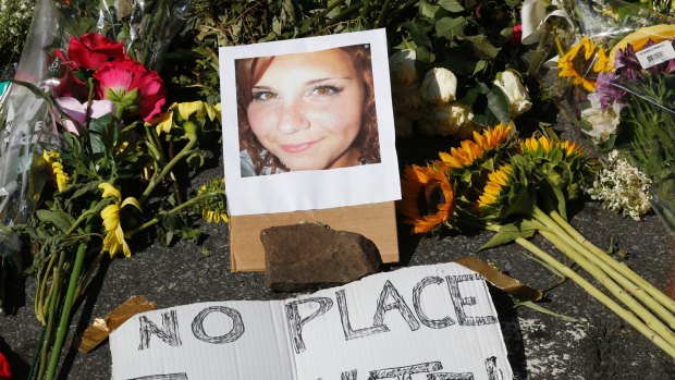A makeshift memorial of flowers and a photo of victim, Heather Heyer, sits in Charlottesville.