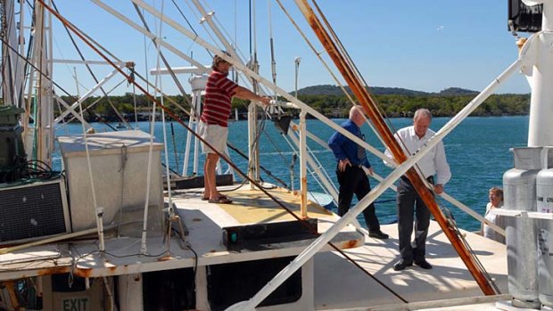 Guiding Star skipper James Hicks (left) shows the wheelhouse roof area to solicitor Vince Campbell and Coroner John Hutton.