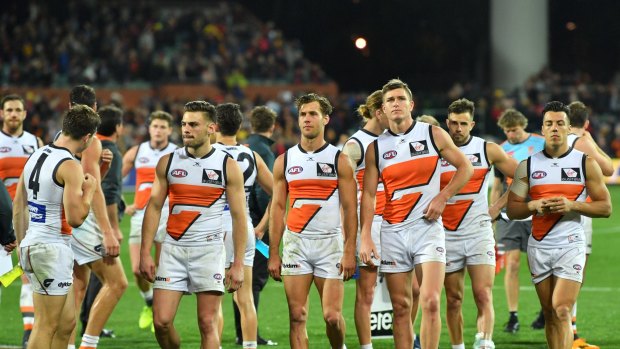 Despondent: The Giants trudge off the field after losing to Adelaide last weekend.