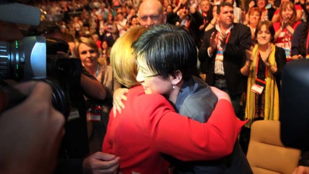 Julia Gillard hugs Penny Wong at Labor's conference.