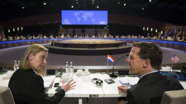 Italy's Foreign Affairs Minister Federica Mogherini, left, talks to Dutch Prime Minister Mark Rutte during the closing session of the Nuclear Security Summit in The Hague, Netherlands. 