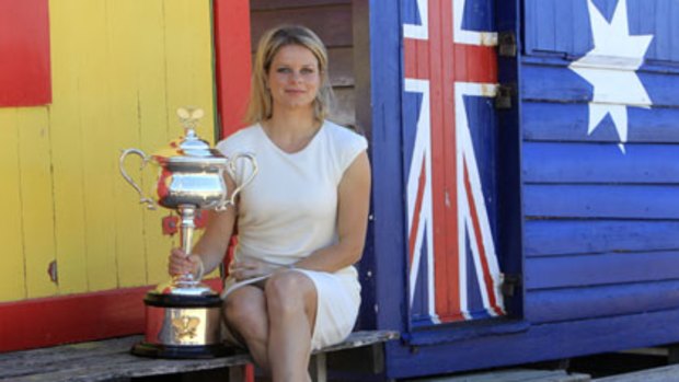 Olympic dream ... Australian Open women’s champion Kim Clijsters poses with the Daphne Akhurst Memorial Cup  at Melbourne’s Brighton Beach yesterday.