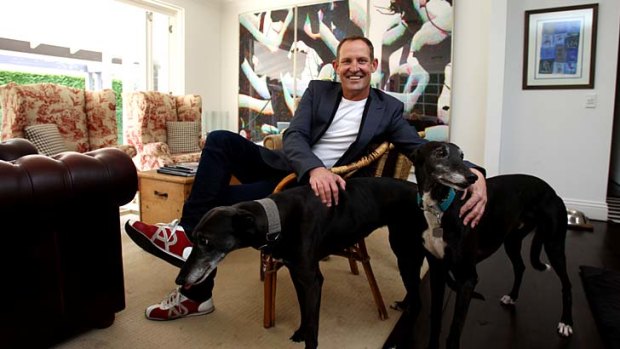 Many faces: Todd McKenney relaxes with his dogs.