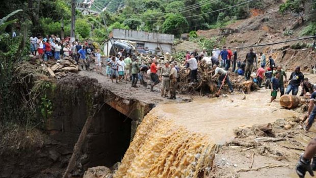 Rescue workers search for victims after heavy rains caused mudslides in a low-income neughbourhood in Teresopolis, some 100 kilometres from Rio de Janeiro.