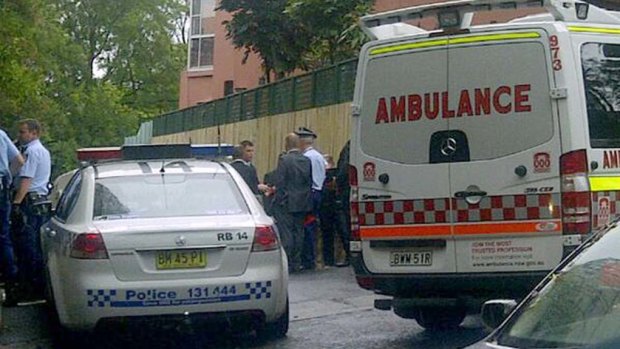 Police and ambulance staff at the scene of the Darling Point stabbing.
