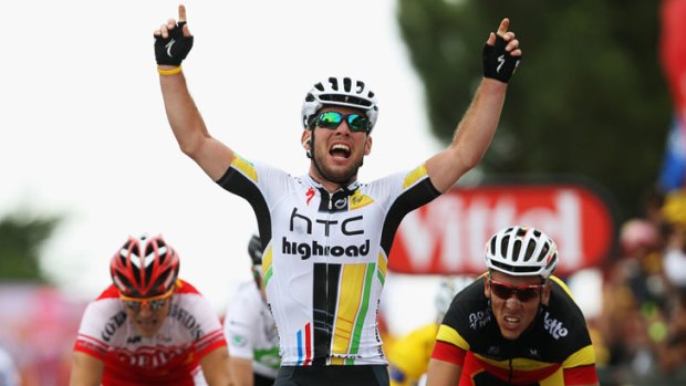 Victory ... Mark Cavendish crosses the finish line and celebrates winning stage five of the Tour de France.