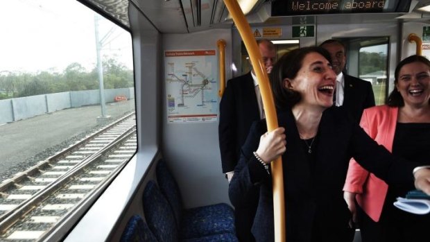 Light moment on new heavy rail: Transport Minister Gladys Berejiklian enjoys the journey.