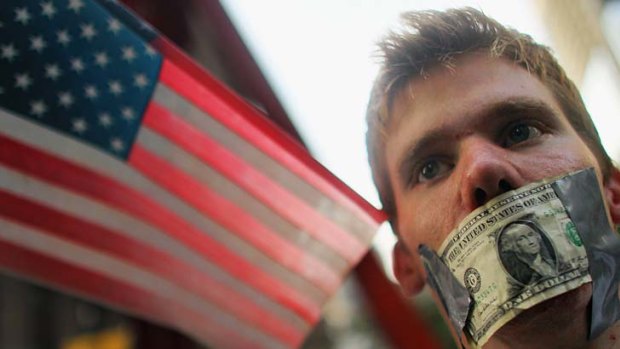 A protester with a dollar bill taped over his mouth on Wall Street.
