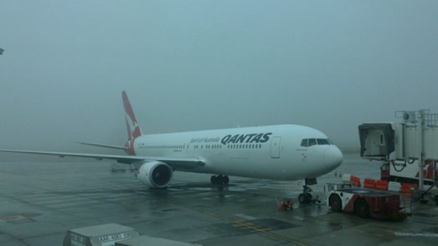 Smoke and fog descends on Perth airport this morning, delaying flights.