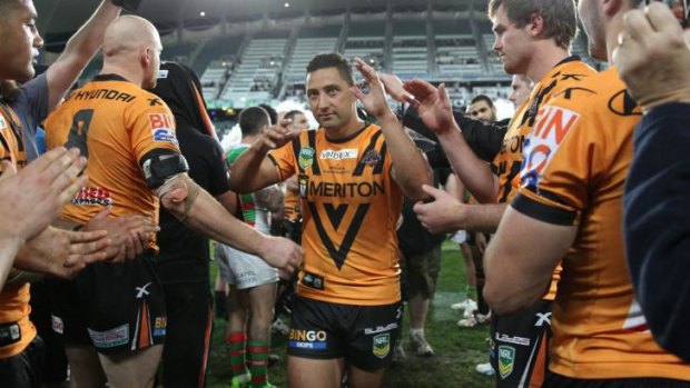 Milestone: Benji Marshall is given a guard of honour by his Wests Tigers teammates after his 200th game for the club last August.