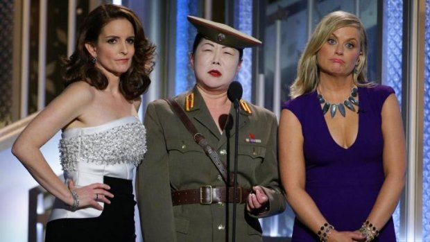Tiny Fey (left), Margaret Cho and Amy Poehler make fun of North Korea at the Golden Globes.