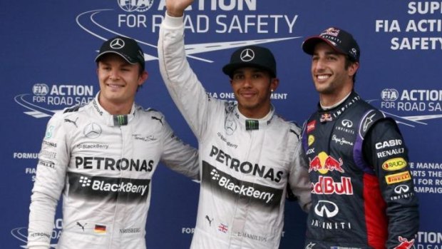 Lewis Hamilton (C) celebrates taking pole position, flanked by Nico Rosberg and Daniel Ricciardo.