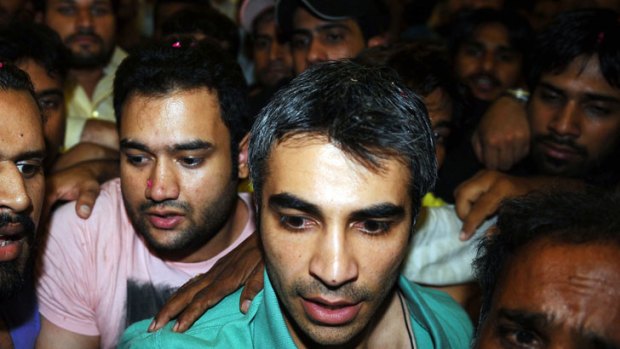 Former Pakistan cricket captain Salman Butt is swamped by supporters as he arrives in Lahore after being freed from a British jail for spot-fixing.
