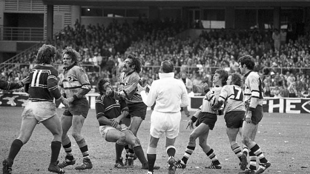 Different era . . .  Manly's Peter Peters, third from left, wears one from Cronulla's Cliff Watson during the 1973 grand final.