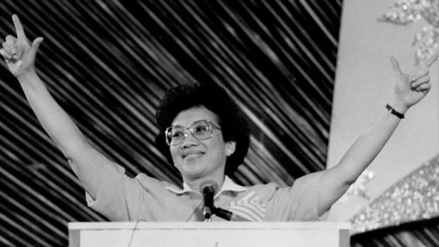 Former Philippine president Corazon Cory Aquino, flashing the 'L' sign for Laban (fight) as she addresses a crowd in early 1989.
