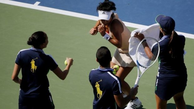 US Open ball boys and girls chase away bees from Kimiko Date-Krumm.