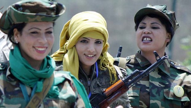 Armed women supporters of the Gaddafi regime after their "graduation ceremony" in Tripoli. The government says all mothers will be turned into "killing machines".