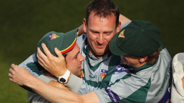 Setting the pace: Allister de Winter (centre) celebrates Tasmania's 2010-11 shield win with Ed Cowan (left) and George Bailey.