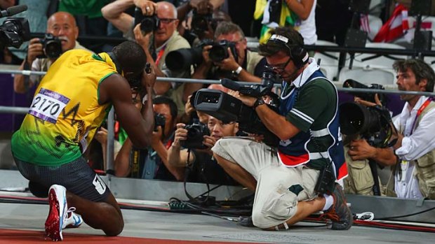 Special shot ... Usain Bolt takes photographs with Jimmy Wixtrom's camera.