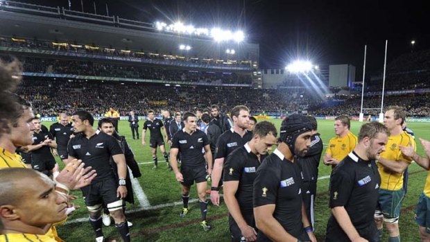 Gallant in defeat ... the Wallabies applaud the New Zealand All Blacks as they leave the field after their Rugby World Cup semifinal at Eden Park.