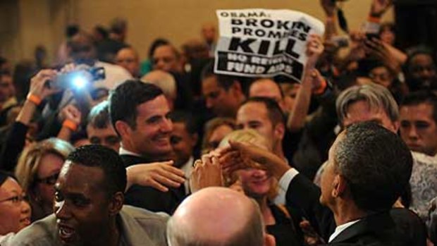 Secret Service hold back protesters who got into the room at the Roosevelt Hotel where President Barack Obama was speaking yesterday.