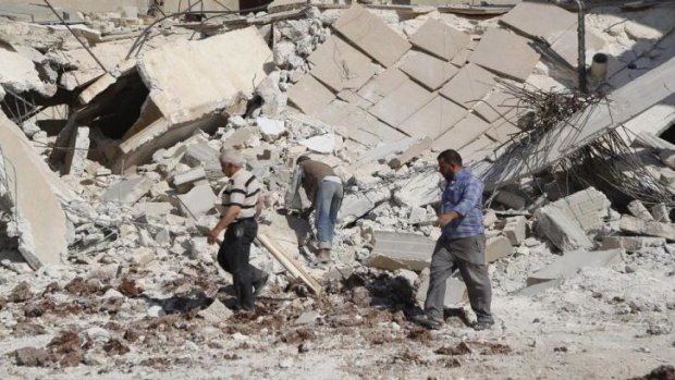 Residents look for belongings under rubble after what activists said was shelling from forces loyal to Syria's president Bashar Al-Assad in Aleppo.
