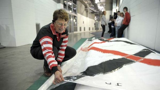 Pam Mawson works on Saints' banner No. 2.