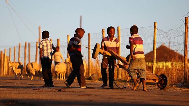 Father of a nation: Boys play in Qunu, where Nelson Mandela lived as a child.