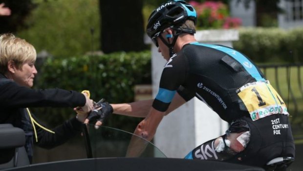 Down but not out: Chris Froome gets some running repairs during stage four of the Tour.