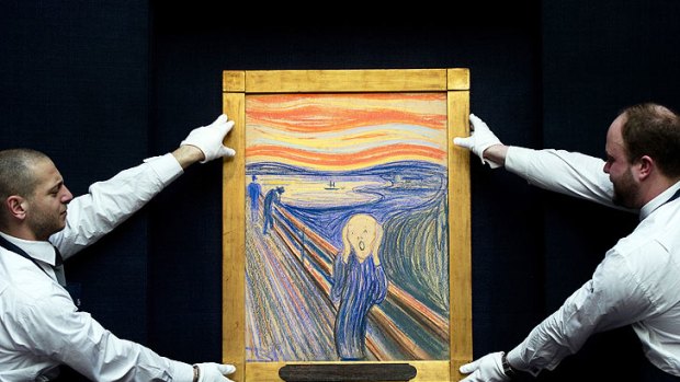 Sotheby's employees hold Edvard Munch's pastel on board version of <i>The Scream</i>.