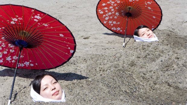 Hot stuff: Two women buried in sand at  Ibusuki.