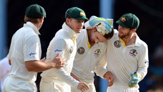Game-changer: Nathan Lyon (third from left) is congratulated after getting Darren Sammy out.