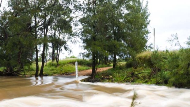 Floods blocking off a road just outside Coonabarabran, in central west NSW.