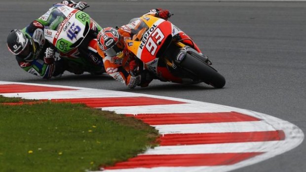 Honda MotoGP rider Marc Marquez of Spain competes with teammate Scott Redding of Britain during the qualifying session for the British Grand Prix at the Silverstone Race Circuit in central England on Saturday.